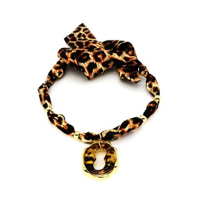 Close-up of leopard print fabric necklace featuring a gold amber resin heart pendant