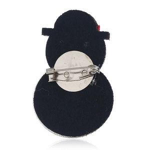Detail view of the back of snowman brooch with silver pin buckle on black fabric