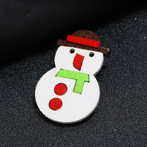Christmas snowman fabric brooch with glitter finish and green scarf on black leather background