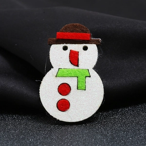 Christmas snowman brooch with white glitter coating and brown felt hat on grey background