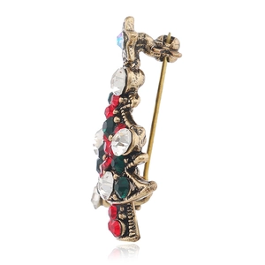 Side view of crystal Christmas tree brooch showing the back pin and vintage gold finish