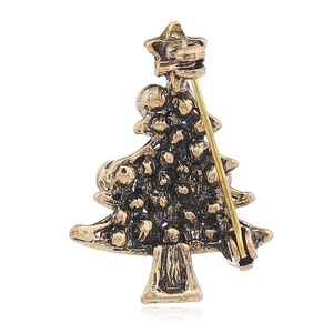 Detailed back view of a vintage crystal Christmas tree brooch with golden pin closure