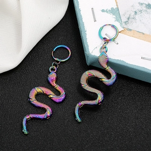 Chic rainbow gradient snake earrings with detailed scale texture on a black background