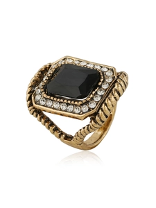 Detail of vintage gold ring with black square stone and clear crystal halo