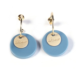 Detail of Morandi blue earrings with golden Love engraved charms and round disc drops
