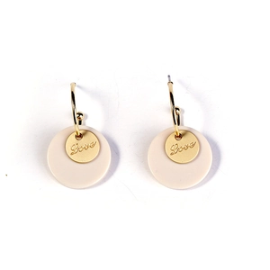 Detailed macro view of minimalist gold hoop earrings with cream round drop and Love engraving