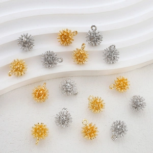 Macro view of 14k gold and silver sea urchin star pendants for DIY jewelry making
