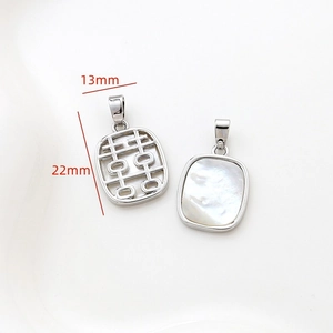 Detail of 14k gold-filled square pendant with hollow Xi character and white mother of pearl