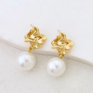 Close-up of S925 silver irregular gold-plated earring studs with large white pearls