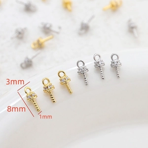 Macro view showing 3mm gold and silver eye pin pendants with micro-pave cubic zirconia