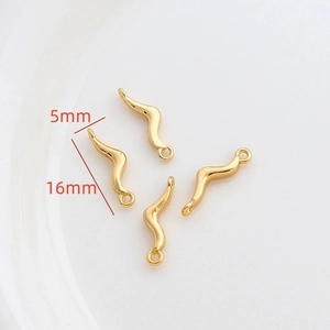 Macro detail of wave-shaped 14k gold plated jewelry connectors measuring 16mm by 5mm