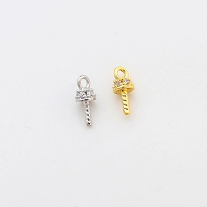Detailed macro of gold and silver plated pearl peg pendants with micro-pave zircons