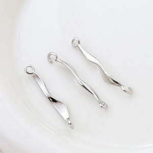Close-up of three silver irregular wavy metal connectors for DIY jewelry making