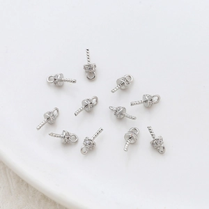 Macro shot of silver plated mini pearl peg bails with zircon stones for jewelry making
