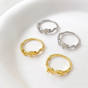 Detailed macro view of gold and silver plated lava style DIY ring bases with mounting pins