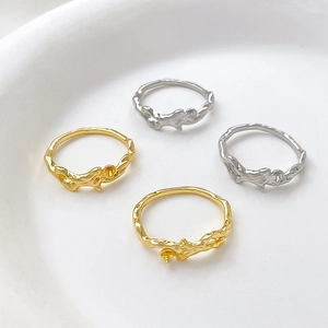 Macro view of gold and silver vine-textured DIY ring settings with pegs for pearls