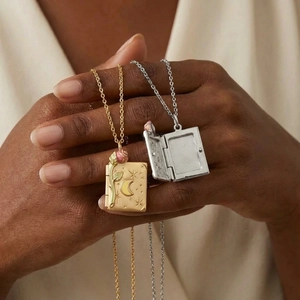 Handheld vintage book locket necklace in gold and silver with rose and moon embossed detail