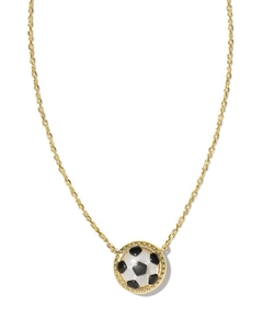 Macro detail of golden chain necklace with soccer ball pendant in black and white enamel