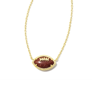 Macro shot of American football pendant with gold-tone stitching and brown gemstone