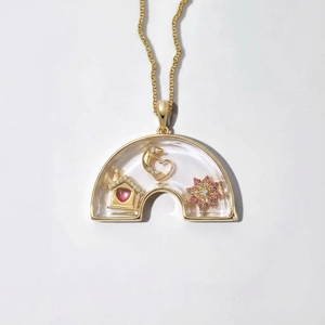 Macro shot of gold rainbow locket necklace with transparent sapphire glass design