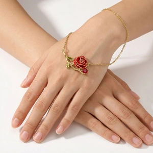 Vintage gold necklace with red enamel rose pendant and green leaves on a female model