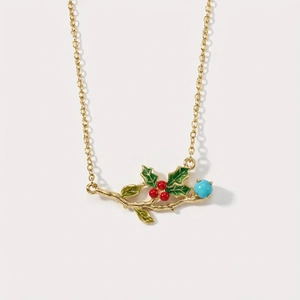 Detail of holly branch pendant with green enamel leaves, red berries, and blue stone