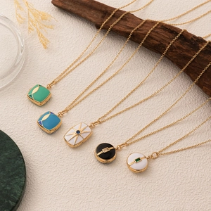 Collection of vintage gold plated pendant necklaces with colorful enamel and charms