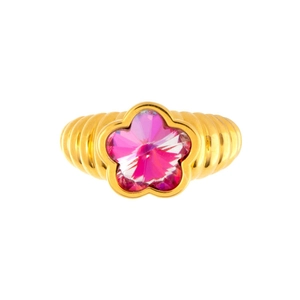 Detail of flower shaped ring with gold wavy band and vibrant pink crystal gemstone