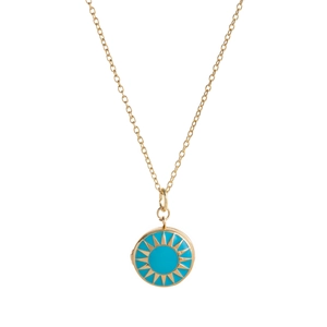 Close-up of golden necklace with turquoise enamel round pendant featuring sunburst motifs