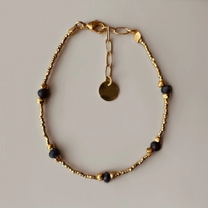 Beaded bracelet with gold metal and black faceted beads with adjustable lobster clasp