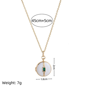 Vintage gold necklace with white enamel round pendant and green gemstone detail