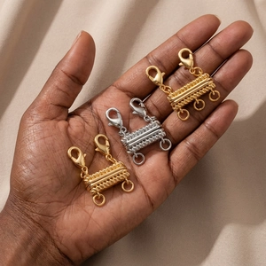 Detail of magnetic layered necklace clasps in gold and silver with lobster clips
