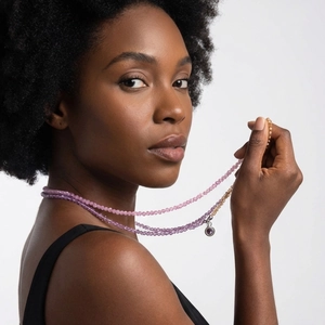 Multilayer colorful beaded necklace with purple zircon pendant on a fashion model