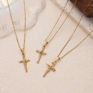 Détail du collier pendentif croix doré avec motifs floraux et cristal incrusté élégant