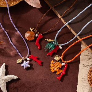 Creative ocean-themed necklaces with starfish, coral, and fish pendants on colorful silk cords