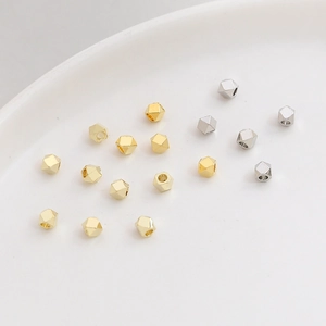 Macro shot of gold and silver faceted metal spacer beads for DIY jewelry making