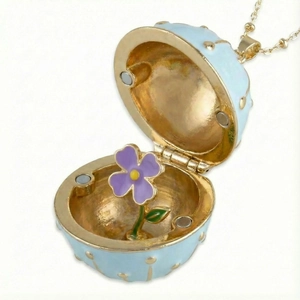 Light blue Faberge style egg pendant necklace with golden dots and purple flower inside