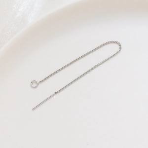 Close-up of a silver ear threader chain with needles and loop for DIY jewelry making