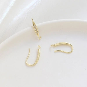 Detail of 14k gold-plated U-shaped earring hooks with micro-pave cubic zirconia accents