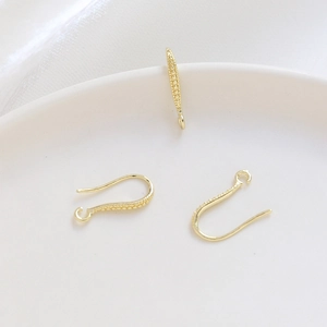 Close-up of 14k gold plated U-shaped ear hooks with beaded texture for DIY jewelry