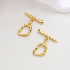 Close-up of polished 14k gold plated irregular OT toggle clasps for jewelry making