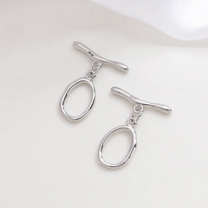Close-up of polished silver-tone OT toggle clasps for DIY jewelry making and necklaces