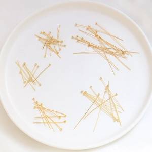 Gold plated ball head pins for DIY jewelry making in various lengths on white display