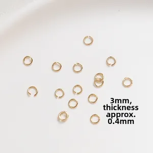 Macro detail of 3mm gold-plated open jump rings with 0.4mm wire thickness for jewelry making