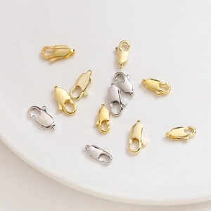 14K gold and silver lobster clasps on ceramic tray for jewelry making DIY