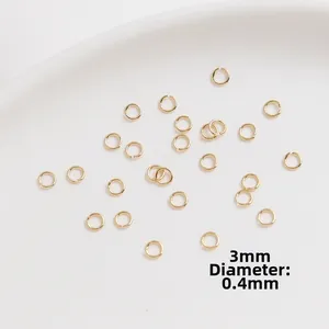 Macro shot of 3mm gold-plated open jump rings with 0.4mm wire thickness for jewelry DIY