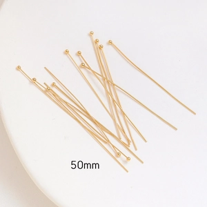 Close-up of 50mm gold-plated ball head pins for DIY jewelry making and bead crafts