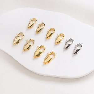Detailed view of polished gold and silver lobster clasps for DIY jewelry making