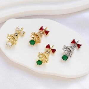Close-up of 14k gold plated Christmas bell pendants with zircon bows for DIY jewelry