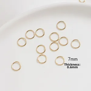 Detail of 7mm gold plated open jump rings with 0.6mm thickness for jewelry DIY